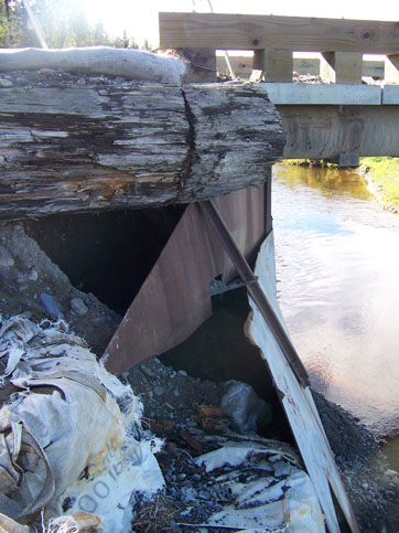 As in previous years, rain has caused damage to abutments of the Tall Tree Avenue bridge across Stariski Creek.-Photo by McKibben Jackinsky, Homer News