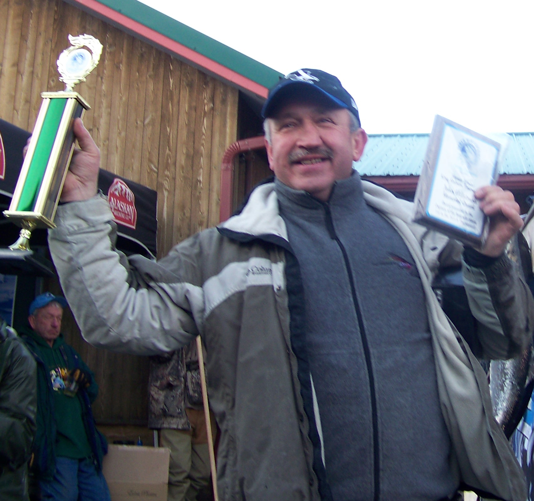 Leszek Kuligowski of Anchorage claims his first-place prize in the Homer Winter King Salmon Tournament.-Photo by McKibben Jackinsky, Homer News