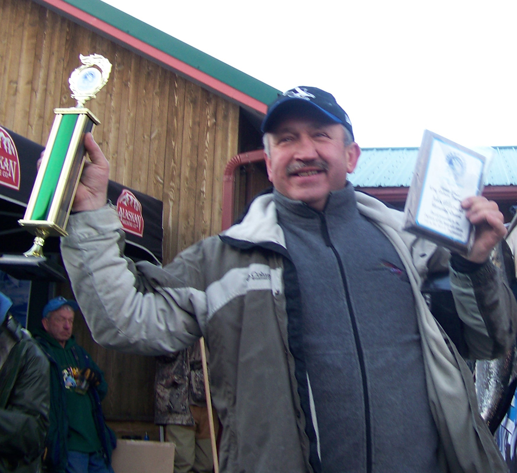 Winner of the 2013 Homer Winter King Salmon Tournament, Leszek Kuligowski of Anchorage claims his first-place trophy and plaque for being captain of the boat with the winning fish following the Saturday event. -Photo by McKibben Jackinsky, Homer News
