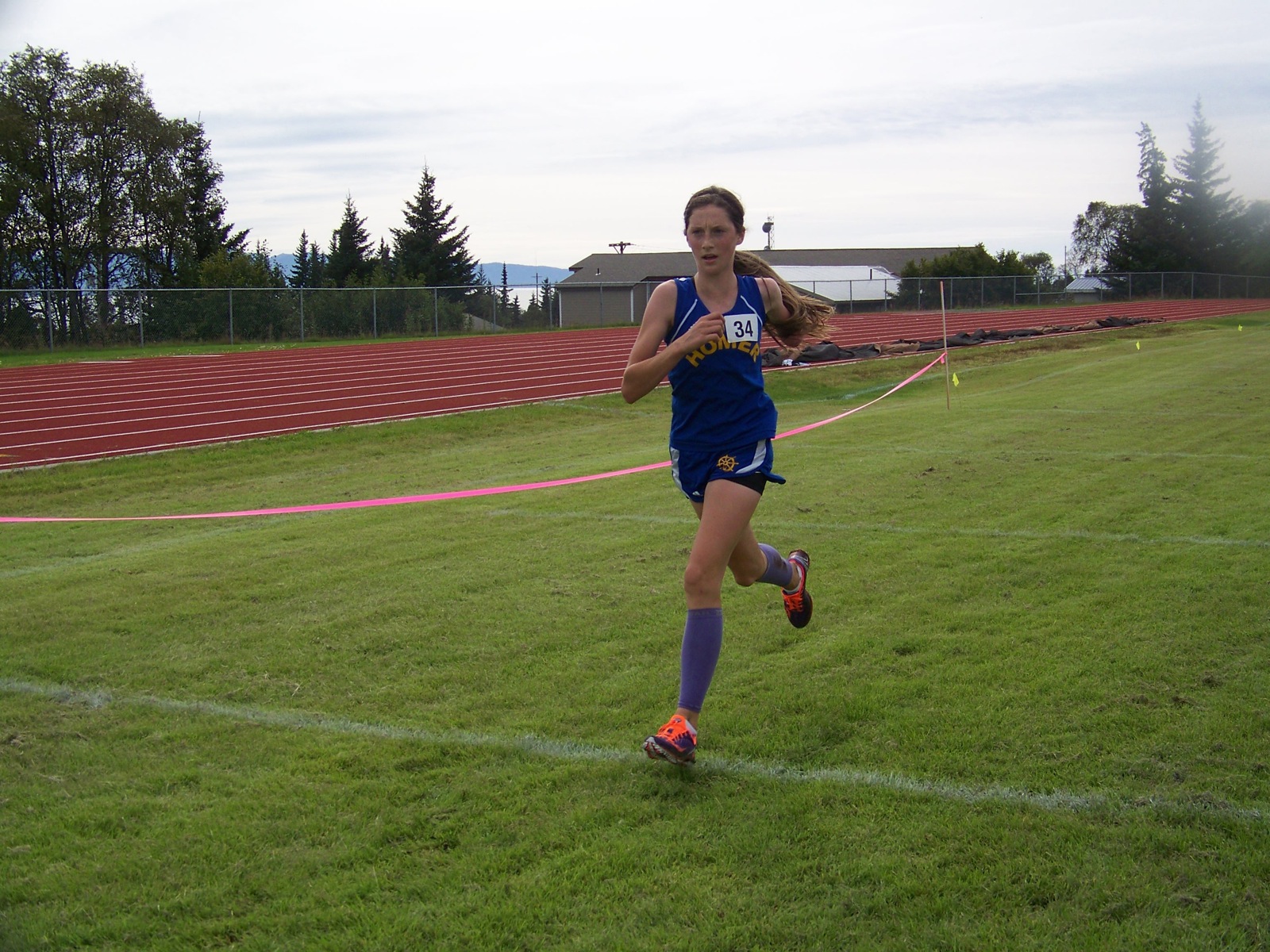 Homer’s Megan Pitzman crosses the finish line in 20:35, a third-place finish.-Photo by McKibben Jackinsky, Homer News