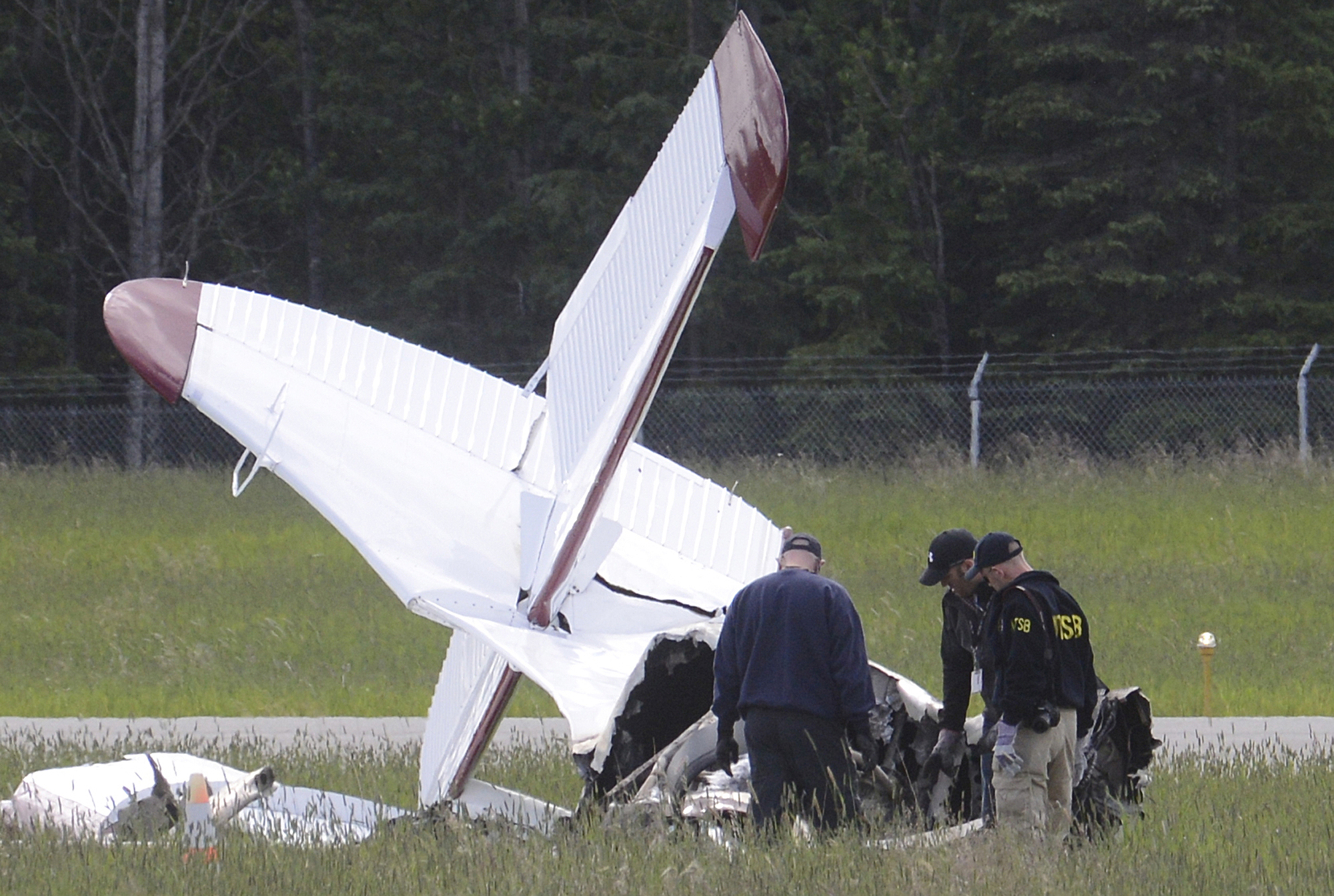 A go-team of National Transportation and Safety Board members examine the remains of an aircraft Monday July 8, 2013 after a wreck killed 10 people at the Soldotna, Alaska airport.-Photo by Rashah McChesney/Peninsula Clarion