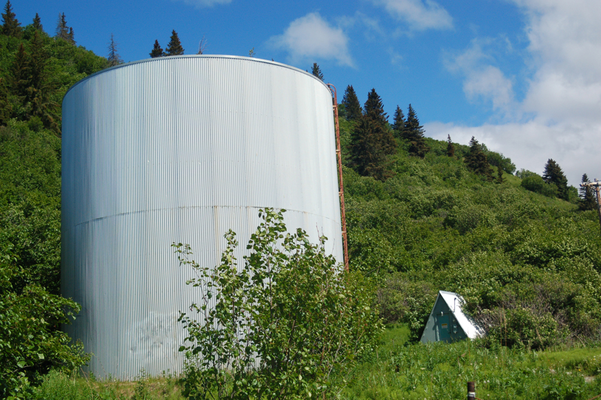 The A-frame building, right, with pressure reduction valve that gives the historic water tank its name is next to the tank at the top of Main Street.-Photo by Michael Armstrong, Homer News