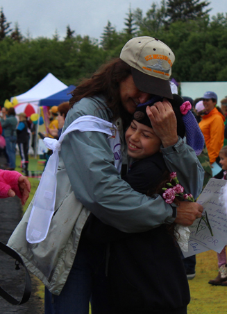 Cancer survivor Pam Augustine of Kittanning, Pa., gets a hug from her niece Delilah Harris of Homer on Friday at the Relay for Life of Homer. -Photo by McKibben Jackinsky, Homer News