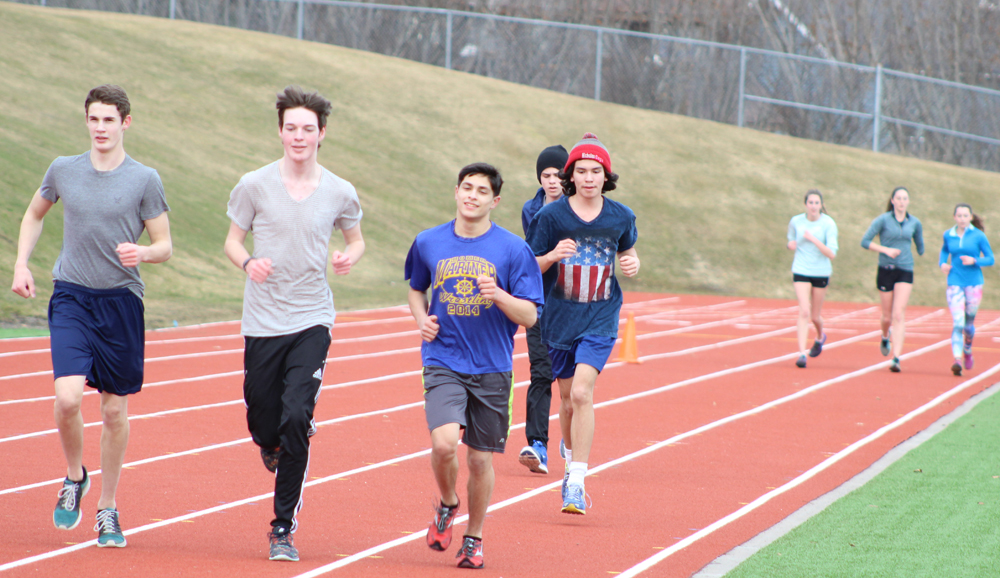 Distance runners junior Jared Brant, sophomore Elan Carroll and freshmen Luciano Fasulo, Corbin Mattingly and Bill Rich run on the Homer High School track with juniors Audrey Rosencrans and Megan Pitzman, and sophomore Alex Moseley following behind.-Photo by Anna Frost, Homer News