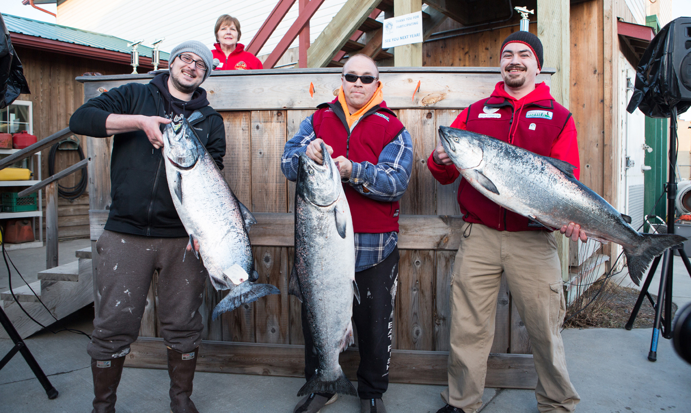 Winners of the 2015 Winter King Tournament, from left to right, Chelsa Johnson of Homer, Mike Olsen of Kodiak and Raymond Tepp of Kenai hold up their winning king salmon. Olsen won first place with a prize of $27,762 for a 30.40-pound fish, Johnson won second place with a prize of $18,508 for a 28.60-pound fish and Tepp won third place with a prize of $14,542 for a 26.50-pound fish. This year’s tournament is March 19.-Photo by Aaron Carpenter, Homer News