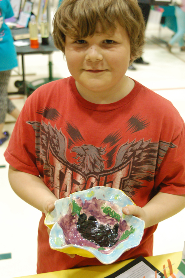 Kamdyn Doughty holds his pottery. As in Burke’s art, Doughty explored images and themes of spring.-Michael Armstrong, Homer News