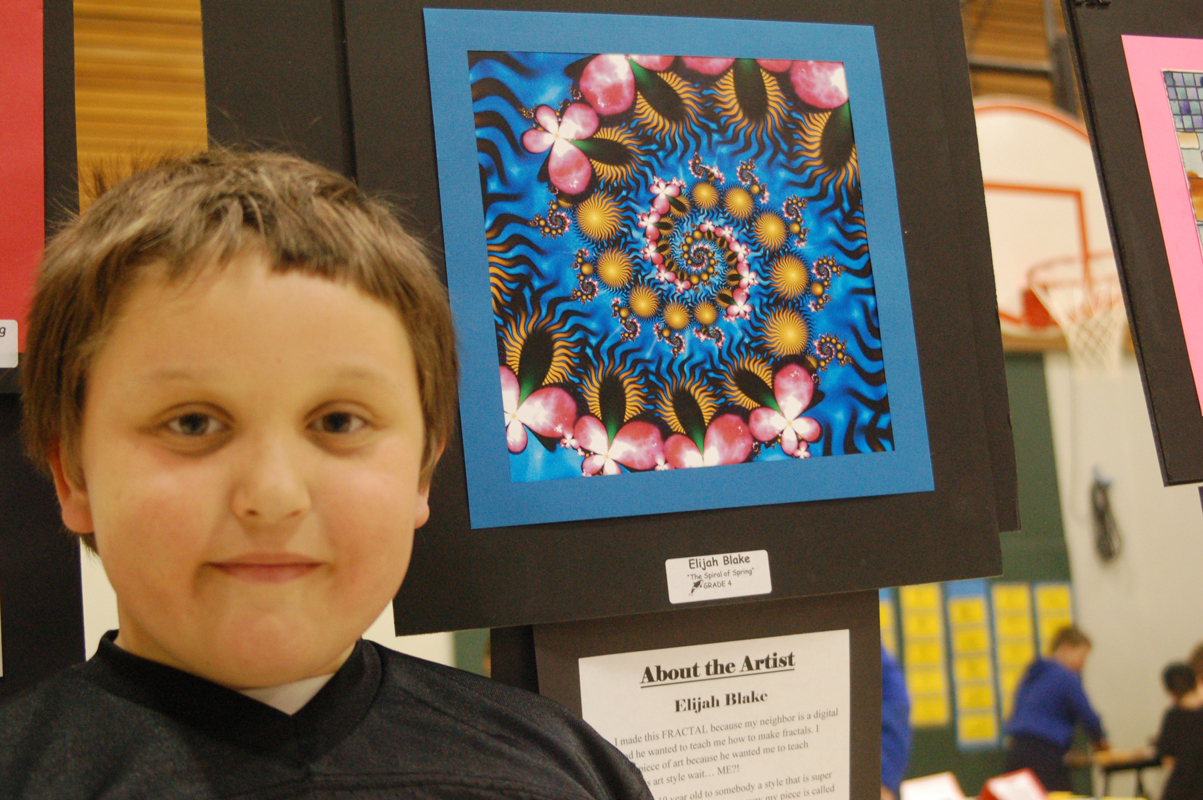 Elijah Burke stands by his digital drawing, “The Spirals of Spring.” Burke made the art using a computer program that generates repeating patterns called fractals.-Michael Armstrong-Homer News