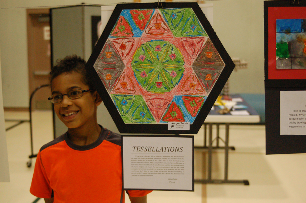 Morgen Techie stands by his painting, “Tesselations.” Many students explored geometric shapes in their art.-Michael Armstrong-Homer News