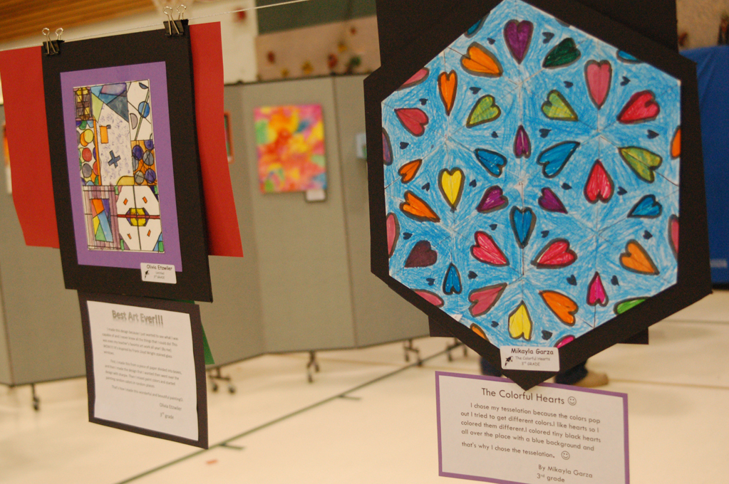 Other work in the art fair is shown. Olivia Etzwiler’s “Best Art Ever!” is at left and Mikayla Garza’s “The Colorful Hearts” is at right.-Michael Armstrong-Homer News