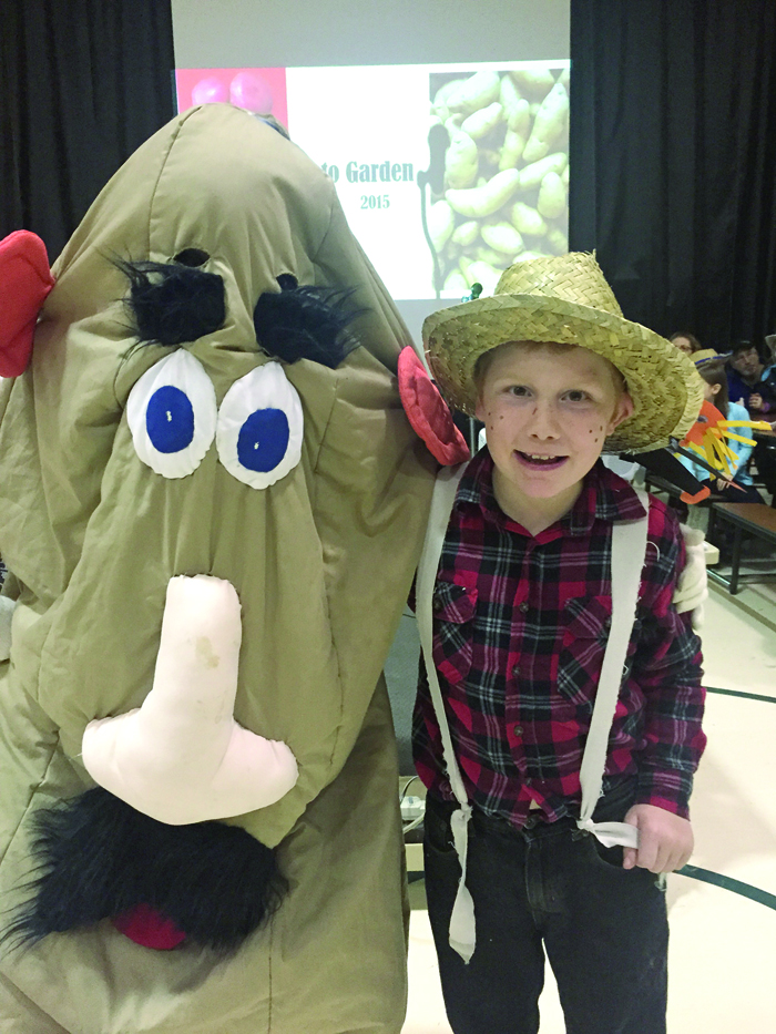 West Homer Elementary fourth-grade teacher Robyn Walls, dressed as a potato, poses with fourth-grade farmer Dylan Jones at the school’s annual Potato Fest on Oct. 15.-photo by Mindy Lewis