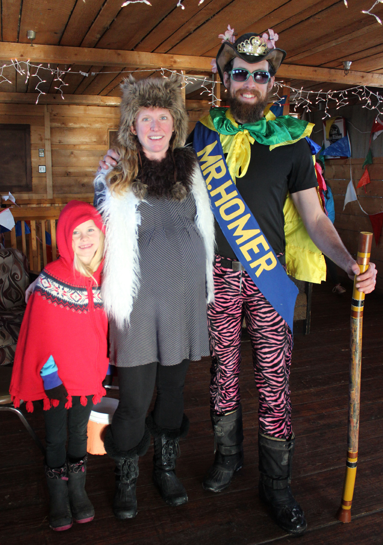The costumed Thoning family gets ready for the start of Sunday’s Ski For Women. From left are Brightly Thoning as Little Red Riding Hood, Beka Thoning as a wolf, and Lucas Thoning, who was crowned Mr. Homer at the 2014 Homer Winter Carnival.-Photo by McKibben Jackinsky, Homer News