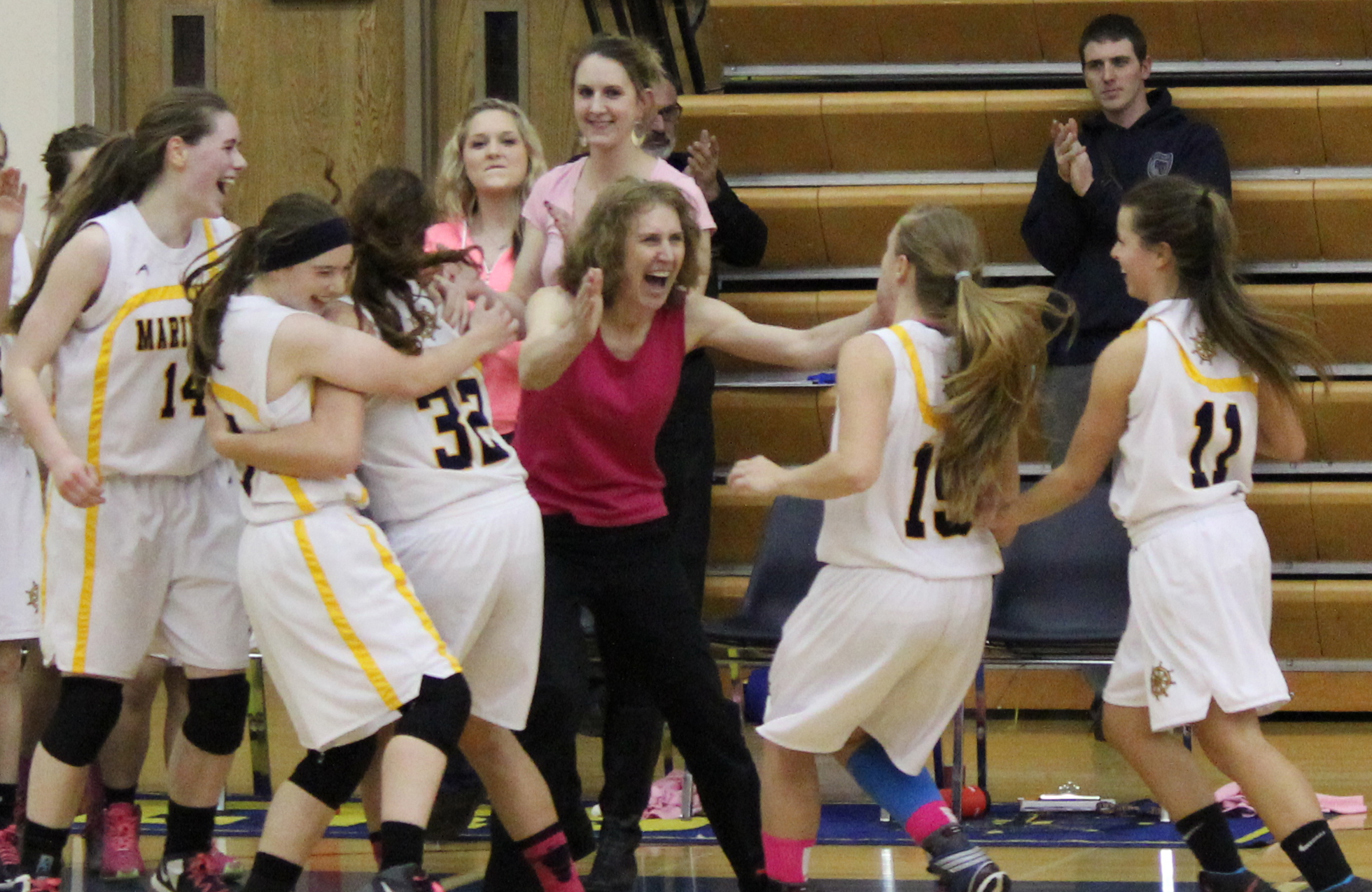 Mariner Head Coach Connie Akers, center, and members of her varsity team celebrate Monday night’s victory against the Nikiski Bulldogs. Mariners, from left, are Madison Akers, Samantha Draves, Tayla Cabana, Larsen Fellows and Maggie Koplin.-Photo by McKibben Jackinsky, Homer News