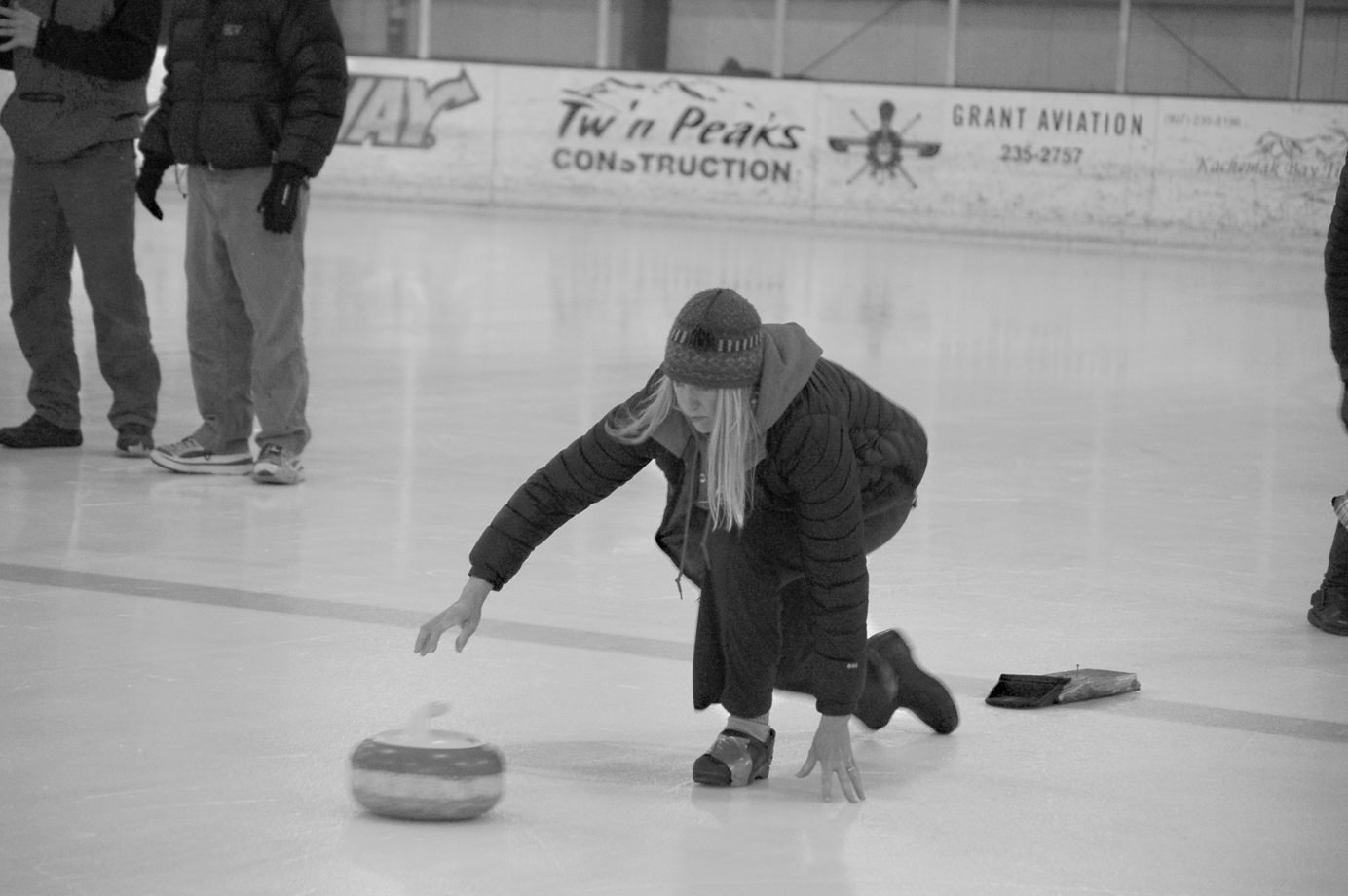 Michelle Hatten throws a stone durlng a curling demonstration in November of 2012 for the Homer Hockey Association’s Kevin Bell Appreciation Day. Hatten improvised a curling shoe by wrapping duct tape around the shoe. The Kevin Bell Ice Arena was the curling venue when it first opened for the 2006 Arctic Winter Games.-Photo by Michael Armstrong, Homer News