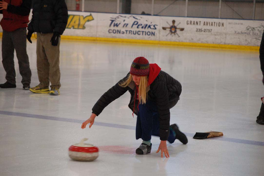 Michelle Hatten throws a stone during the curling demonstration. Hatten improvised a curling shoe by wrapping duct tape around the shoe.