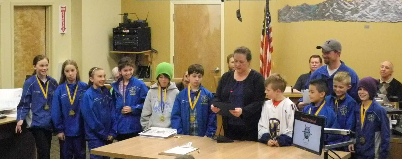 Homer Mayor Beth Wythe reads a proclamation honoring the Homer Glacier Kings Squirts hockey team state champions at the Homer City Council meeting on Monday. Honored were team members, in no order, Rachel Bolin, Terry Gilliland, Hunter Green, Delilah Harris, Timothy Hatfield, Fiona Hatton, Dylan McBride, Tobias “Jack” Nevak, Casey Otis, Haylee Owen, Kazden Stineff, Keegan Strong, Micah Williamson, head coach Chris Owen and assistant coaches Dave Bolin and Travis Larson.                                                        -Michael Armstrong-Homer News