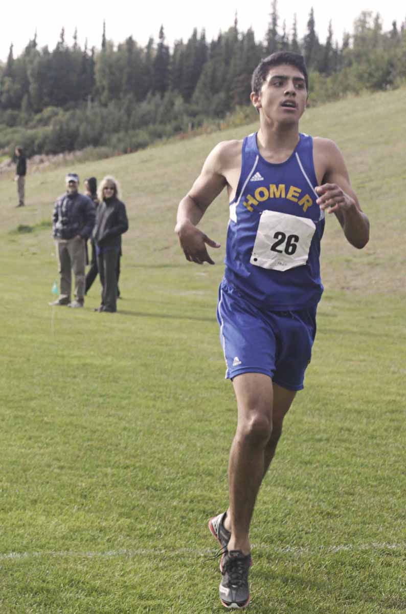 Pedro Ochoa is the first Homer runner to cross the finish line and the third overall in the boys’ varsity race Tuesday during the borough-wide cross country meet at the Tsalteshi Trails in Soldotna. The Homer boys’ team took second place, while the Homer girls team finished in first place. Saturday, the action is closer to home with the Homer Relays on the Lookout Mountain sky trails.-Photo by Rashah McChesney, Morris News Service - Alaska