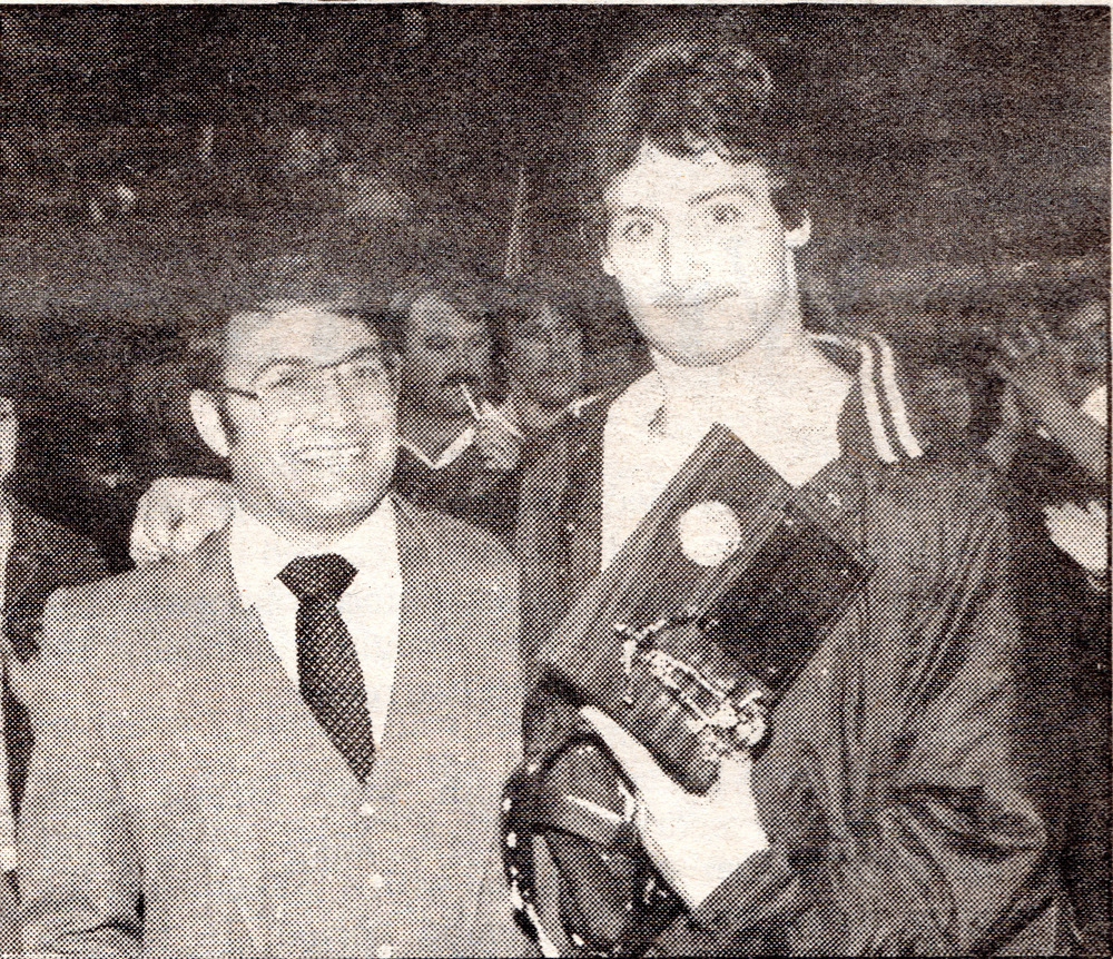 Head coach Steve Wolfe poses with outstanding wrestler and state champion, Ian Pitzman, in 1986. PItzman pinned all three opponents at the state meet.-Homer News file photo