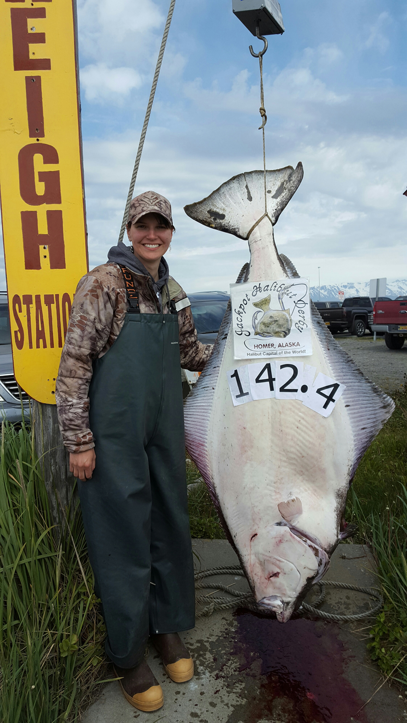 Marcella Kolberg of Palmer poses with a 142.4-pound halibut she reeled in Sunday, May 29. -Photo provided