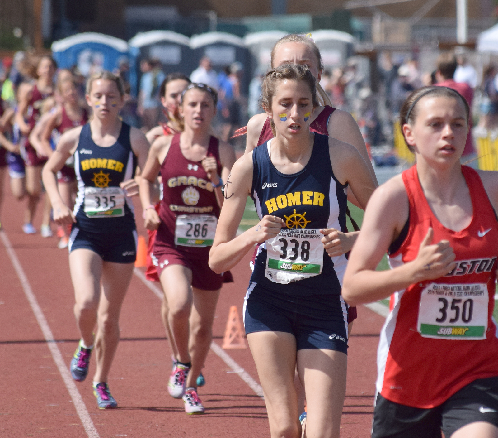 Homer's Audrey Rosencrans (338) runs with Mariners teammate Alex Moseley (335) near the front of the girls 1-2-3A 1,600-meter race Saturday at Dimond Alumni Field in Anchorage.-Photo by Joey Klecka, Peninsula Clarion
