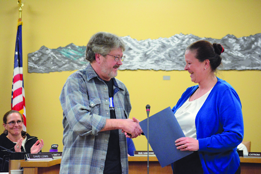 Former KBBI Public Radio General Manager Dave Anderson, left, shakes Homer Mayor Beth Wythe’s hand after she recognized him for his 35 years of service to the station at the March 29 Homer City Council meeting. Anderson retired last Friday and there is a party for him at 7:30 p.m. Friday at Alice’s Champagne Palace.