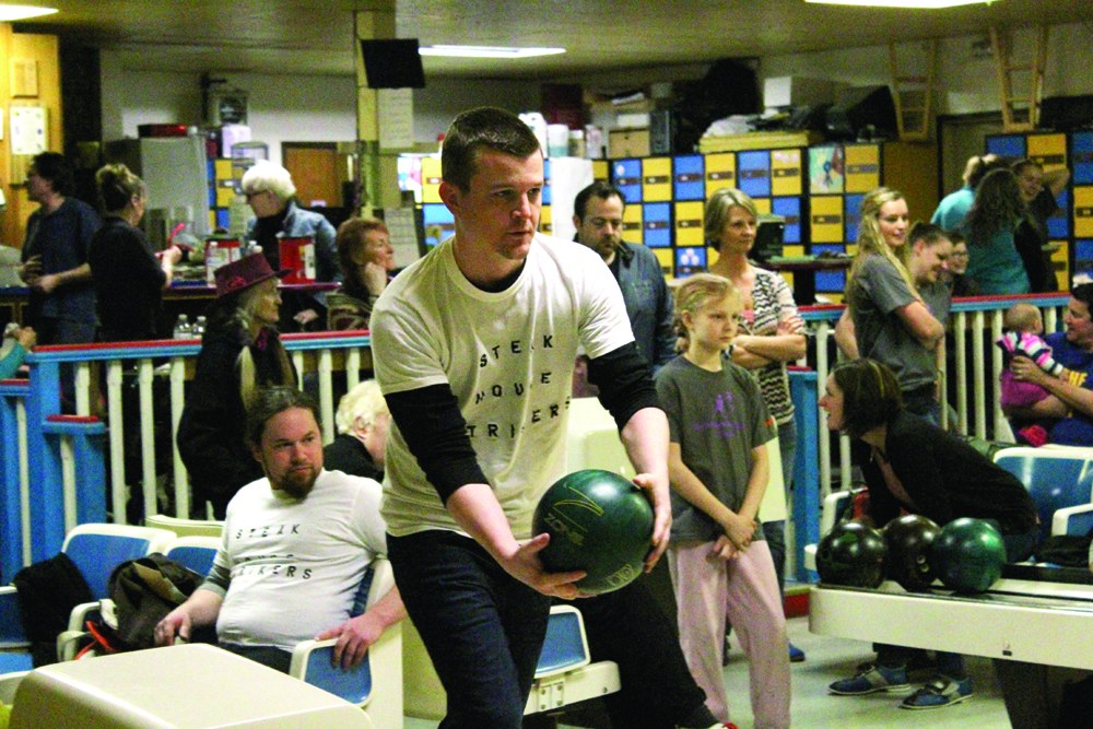 Ryan Jordan steps toward the bowling lane during his turn at the Big Brothers Big Sisters Bowl for Kids Sake event at Kachemak Bowl on Saturday, April 2. Jordan bowled with the Steakhouse Strikers, AJ’s Steakhouse and Tavern’s team, which raised $75 for the fundraiser, according to the Big Brothers Big Sisters of Alaska website.-Photo by Anna Frost, Homer News