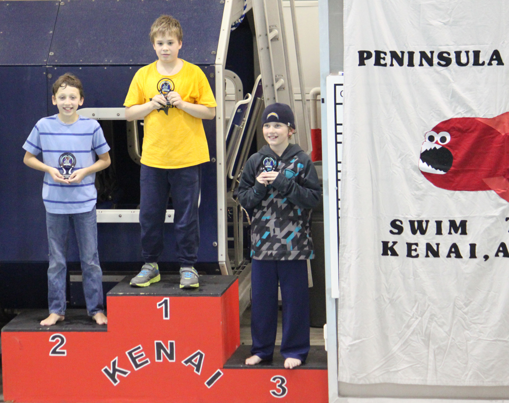KSC King swimmers Luke Nelson, Lukas Story and Nathan Overson stand on the  first, second and third place podiums, respectively, after receiving high point honors in the Southcentral Area Sprint Championship Meet in Kenai last weekend.-Photo provided