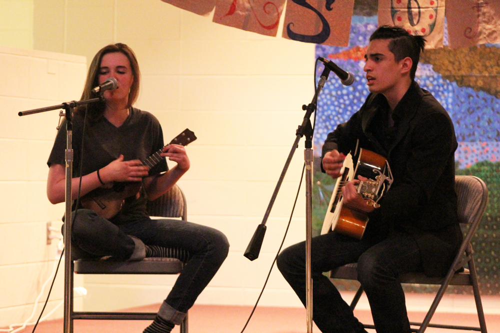 Rachel Seneff and Angelo Amarello (left to right) sing Bang Bang by Nancy Sinatra while playing the ukelee and the guitar. The duo performed on Saturday, April 16 at Homer High School for the spring Colors of Homer event.-Photo by Anna Frost; Homer News