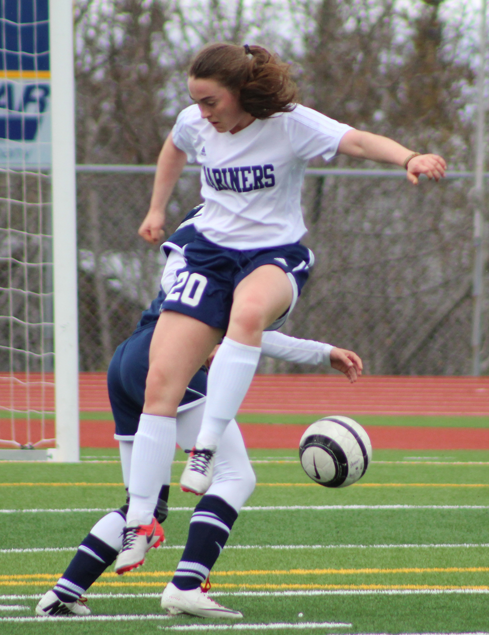 Alison McCarron leaps toward the ball as a Soldotna player kicks it away. Homer girls played Soldotna on Tuesday, April 19 and finished with a 3-0 loss.-Photo by Anna Frost; Homer News