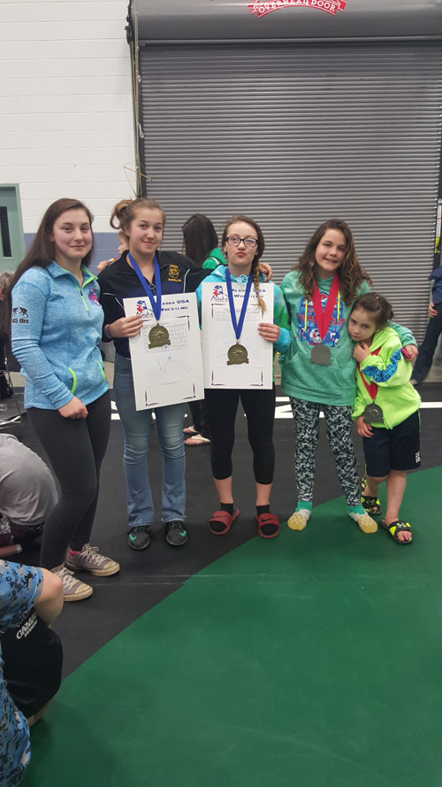 State champions McKenzi Cook, Mina Cavasos and Sadie Blake and second place winners Zoe Adkins and Soairse Cook show off their awards at the 2016 Alaska State Wrestling Tournament. Over the April 29 weekend, Popeye wrestling picked up 28 medals.-Photo provided