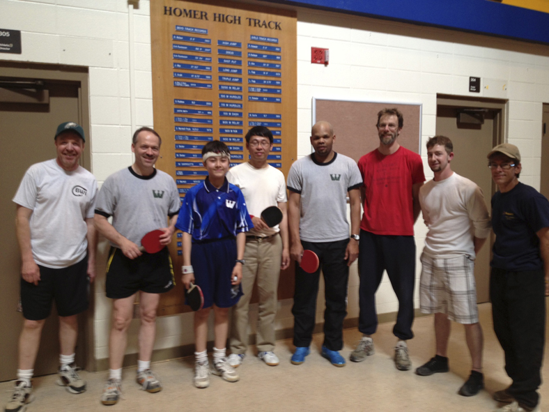 National Public Radio puzzlemaster Will Shortz, second from left, and Robert Roberts, fourth from right and the top ranked U.S. table-tennis player, join Homer ping-pong players last weekend at Homer High School. From left to right are Dan Kroph, Shortz, Jimmy and Gary Gao, Roberts, Dale Banks, Matt Faris and Kyle, last name not known. Shortz visited Alaska as part of his goal to play ping pong in all 50 states.-Photo by Mary Kate Green