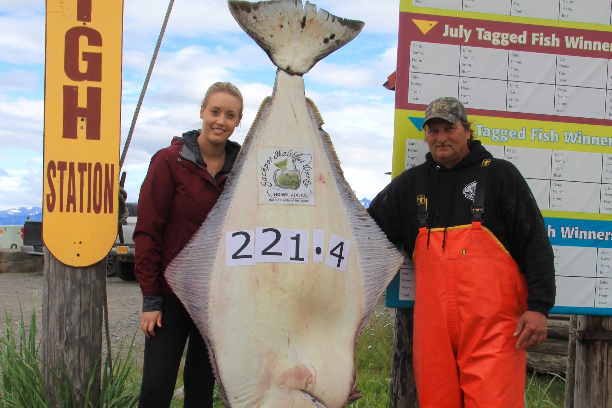 Ashley Camp, left, of Vancouver, British Columbia, Canada, poses with her 221.4-pound halibut caught on July 28, 2018 near Homer, Alaska. She caught the current Homer Jackpot Halibut Derby leader while fishing with Captain Brian Nollar, right, on the Bell Isles with Midnight Sun Charters. (Photo provided)
