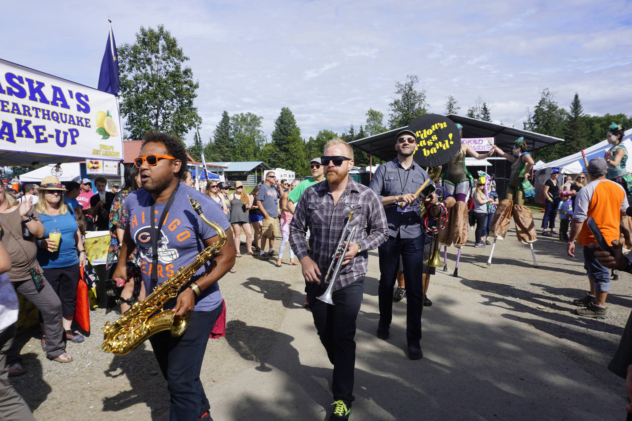 An art and music performance during Salmonfest on Saturday, Aug. 4, 2018, featured women on stilts dressed as mermaids, salmon sculptures and the LowDown Brass Band. Salmonfest attendees enjoyed warm sunny weather on Saturday at the Kenai Peninsula Fairgrounds in Ninilchik, Alaska. (Photo by Michael Armstrong/Homer News)