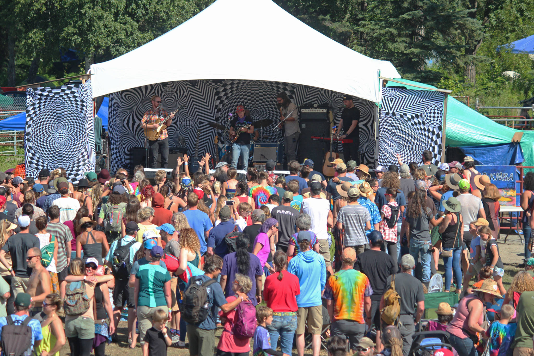 Music lovers listen to a performance on the River Stage at this year’s Salmonfest on Saturday, Aug. 4, 2018 in Ninilchik, Alaska. (Photo by Megan Pacer/Homer News)