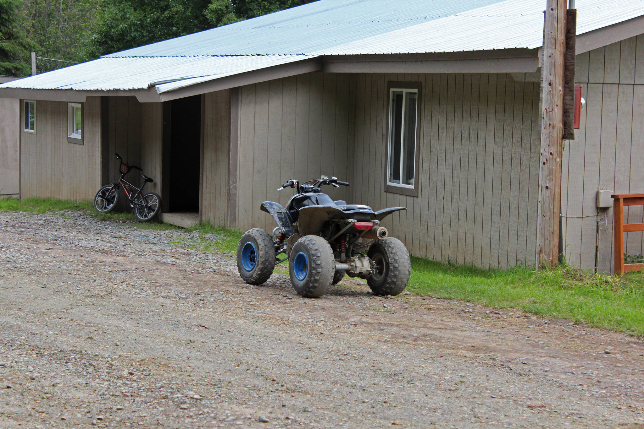 Bicycles and ATVs sit outside one of the two Kachemak Selo School buildings used to teach elementary school children Thursday, Aug. 30, 2018 in Kachemak Selo, Alaska. A grant program through the state would allow the Kenai Peninsula Borough to build a new, combined school facility for the students, as long as borough residents approve the borough to go out to bond for up to a $5 million bond when they vote in the October election. (Photo by Megan Pacer/Homer News)