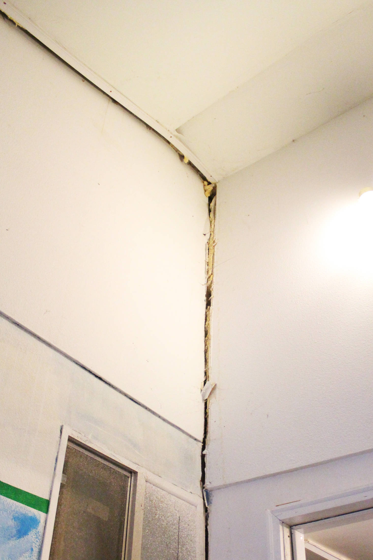A crack runs up to the ceiling where two walls meet in one of the two buildings used to teach elementary students at Kachemak Selo School on Thursday, Aug. 30, 2018 in Kachemak Selo, Alaska. Kenai Peninsula Borough staff and representatives visited the schools to host an information meeting with parents in the community about the proposed project to build a new school on a different site. (Photo by Megan Pacer/Homer News)