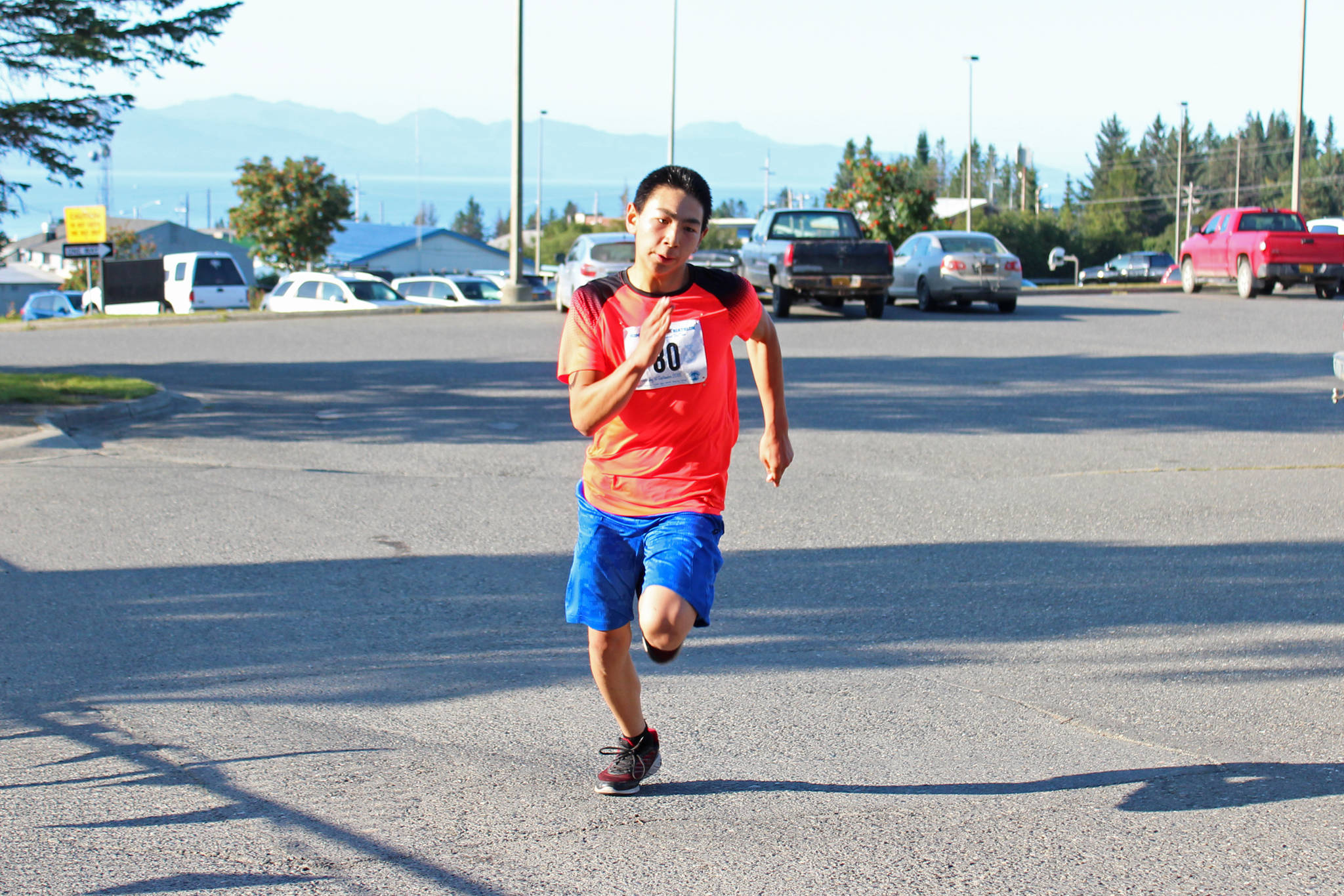 Skyler Rodriguez, a swimmer on the Homer High School swim and dive team, sprints to the finish line of the Homer Mariner Triathlon on Saturday, Sept. 1, 2018 at the high school in Homer, Alaska. (Photo by Megan Pacer/Homer News)