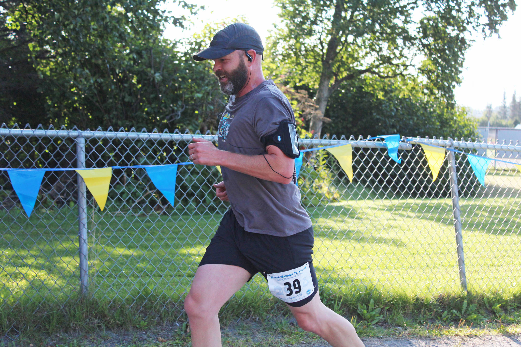 Sean Campbell reaches the finish line of the Homer Mariner Triathlon on Saturday, Sept. 1, 2018 at Homer High School in Homer, Alaska. He completed the running leg of the race for his team, Gutzler’s Return. (Photo by Megan Pacer/Homer News)