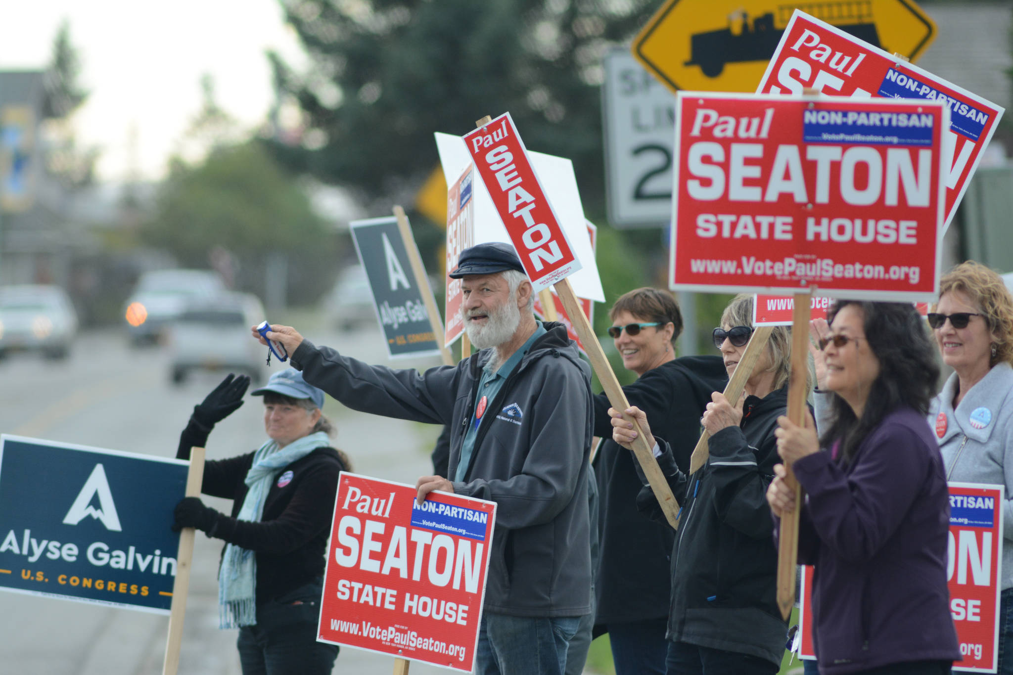 Rep. Paul Seaton, NP-Homer, center, is joined by supporters waving signs on primary election day, Aug. 21, 2018, at the corner of Lake Street and Pioneer Avenue in Homer. Seaton ran unopposed as a nonpartisan candidate for the Alaska Democratic Party seat. Also waving signs are supporters of Alyse Galvin, a nonpartisan candidate for the Democratic Party seat for U.S. Congress. Galvin won the Democratic Party nomination. (Photo by Michael Armstrong/Homer News)