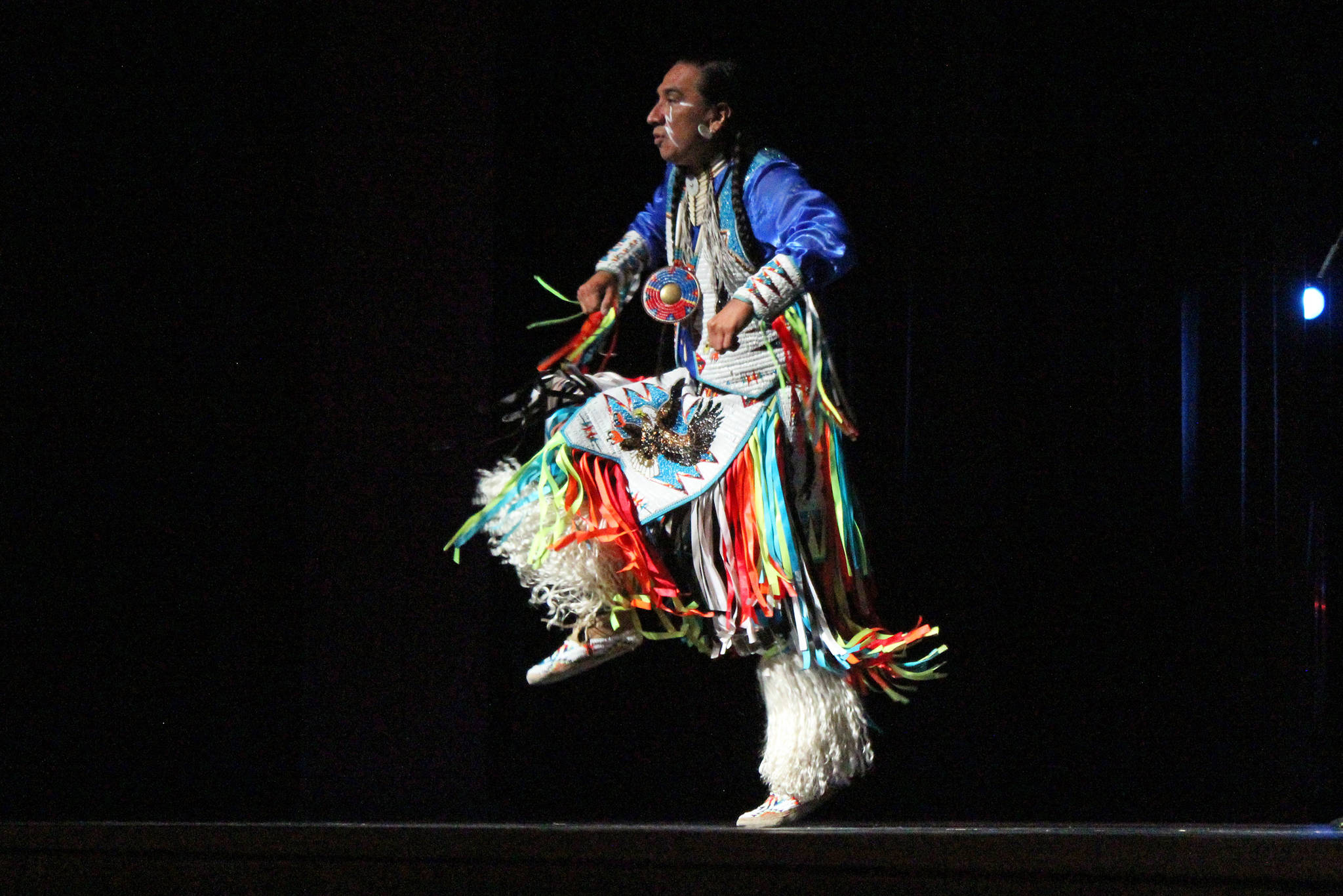 Larry Yazzi performs a dance for a small crowd Thursday, Sept. 6, 2018 in the Homer High School Mariner Theatre in Homer, Alaska. Yazzi’s group, the Native Pride Dancers, traveled from Minnesota to performs in several schools and venues on the Kenai Peninsula. Their visit was made possible by the by the Native Youth Community Project. (Photo by Megan Pacer/Homer News)