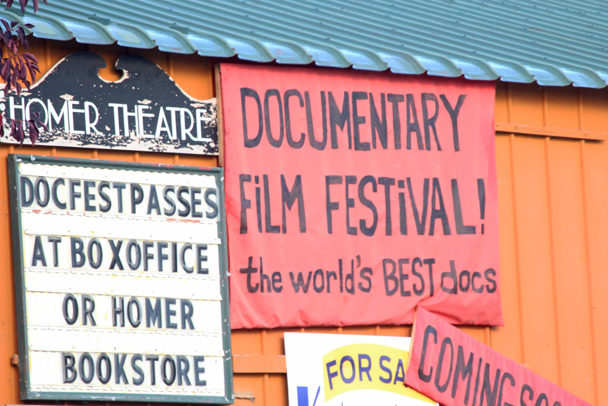 A sign advertising the annual Homer Documentary Film Festival hangs on the side of the Homer Theatre Wednesday, Sept. 19, 2018 in Homer, Alaska. (Photo by Megan Pacer/Homer News)