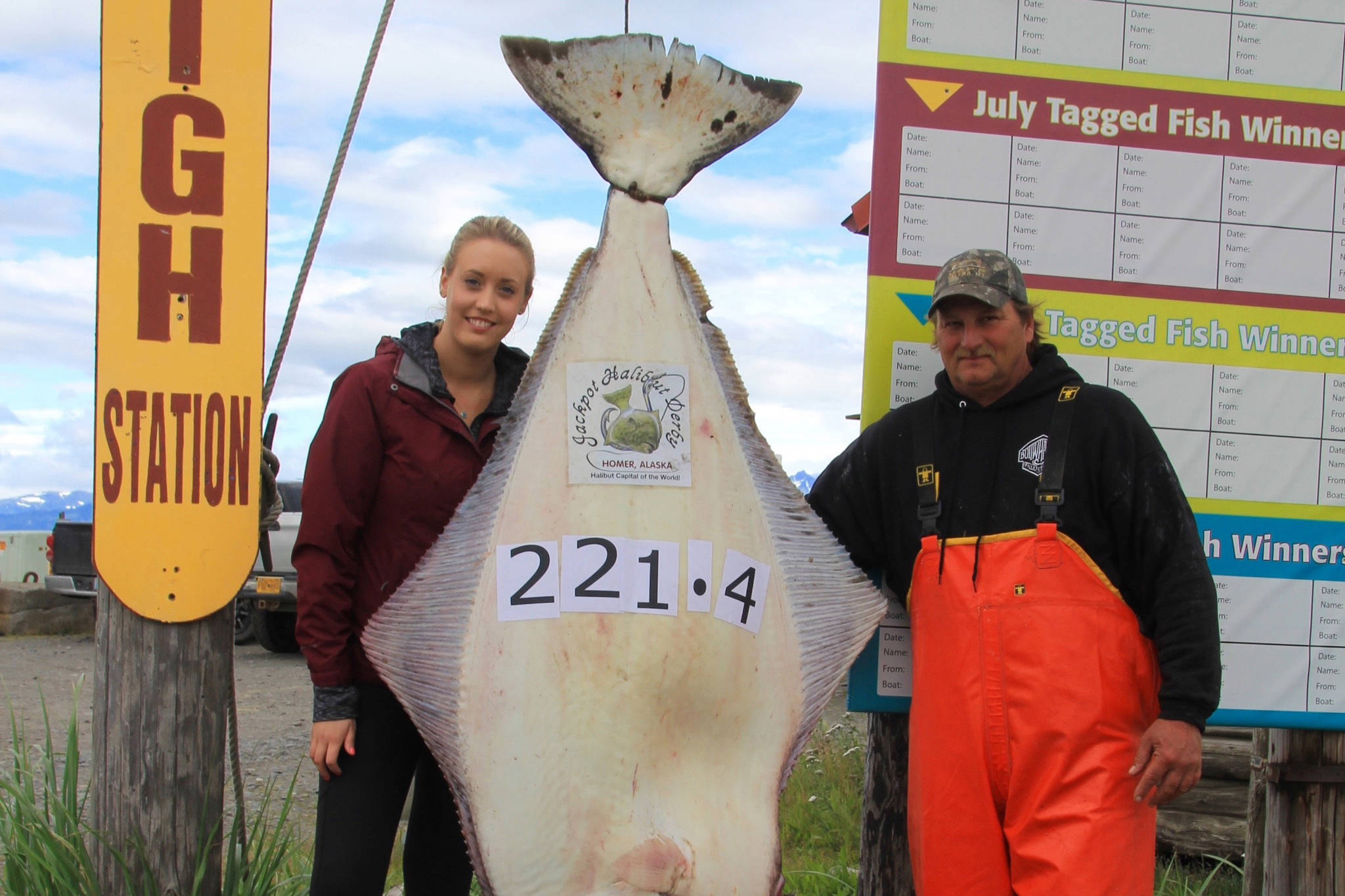 Ashley Camp from Vancouver, British Columbia, poses on July 29 with her 221.4 pound and 76-inch halibut caught while fishing with Midnight Sun Charters and Captain Brian Nollar on the Belle Ile. Camp is the 2018 winner of the Homer Jackpot Halibut Derby. (Photo provided)