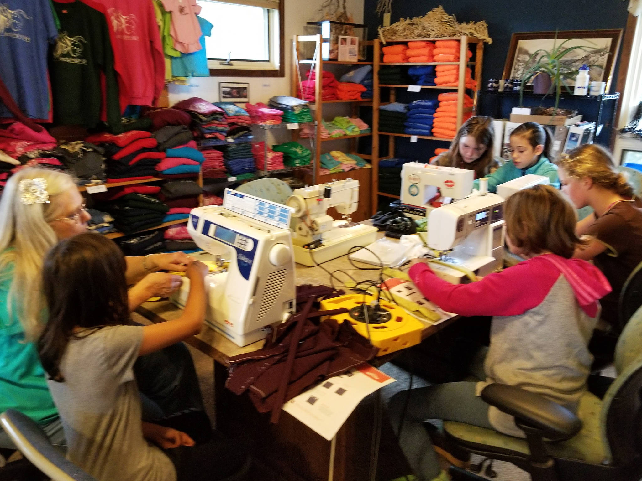 Students from the community help make boomerang bags at the Center for Alaskan Coastal Studies in Homer, Alaska, in October 2017. The center is spearheading an effort to localize the bags, which are the product of an international organization that encourages communities to make the bags as a replacement for plastic ones. (Photo courtesy Beth Trowbridge)