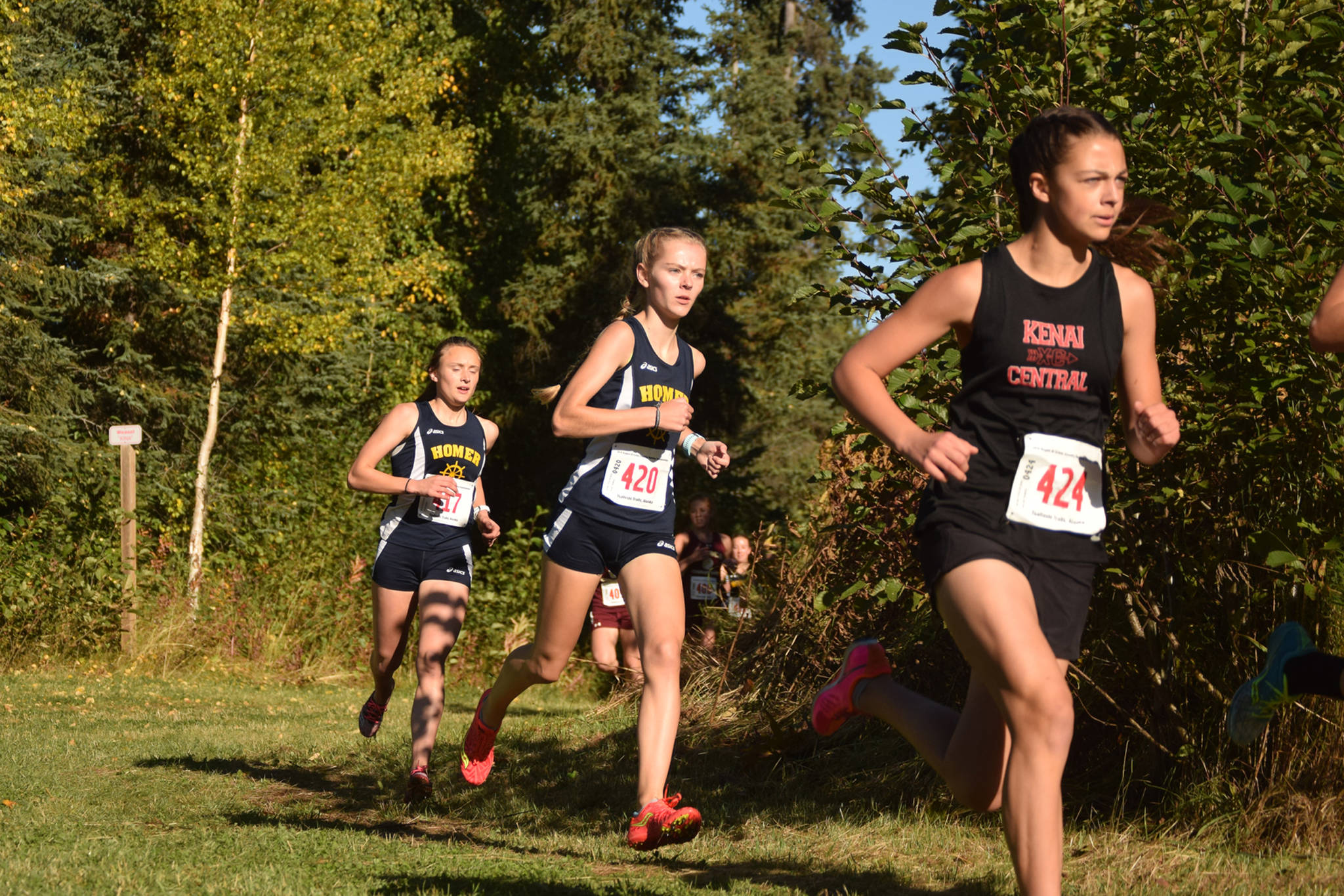 Homer’s Brooke Miller and Autumn Daigle trail Kenai’s Summer Foster early in Division II race at Region 3 meet Saturday, Sept. 22, 2018 at Tsalteshi Trails in Soldotna, Alaska. (Photo by Jeff Helminiak. Peninsula Clarion)