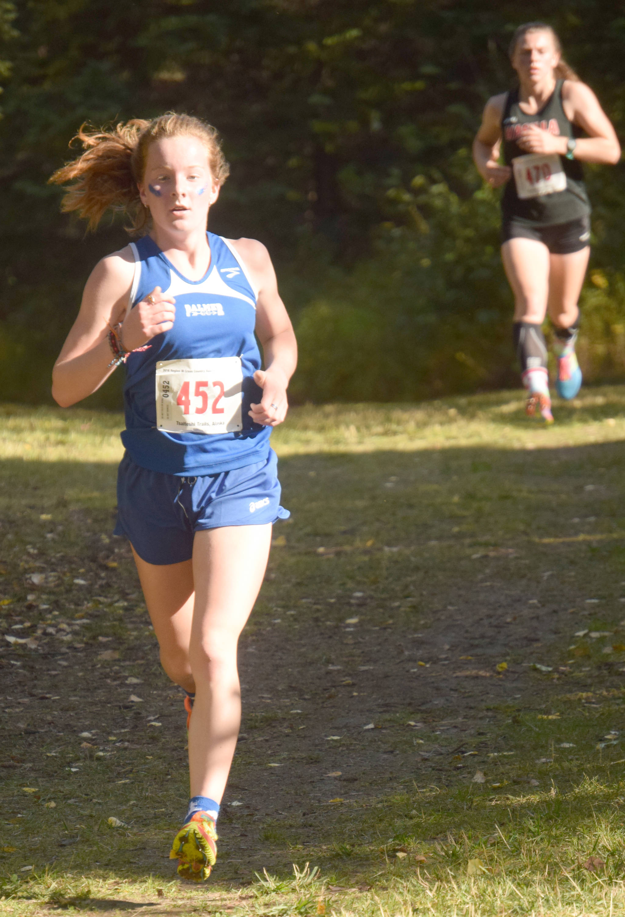 Palmer’s Katey Houser leads Wasilla’s Allison VanPelt with about a kilometer left in the Division I girls race at the Region 3 meet at Tsalteshi Trails on Saturday, Sept. 22, 2018. Houser won, while VanPelt was second. (Photo by Jeff Helminiak/Peninsula Clarion)