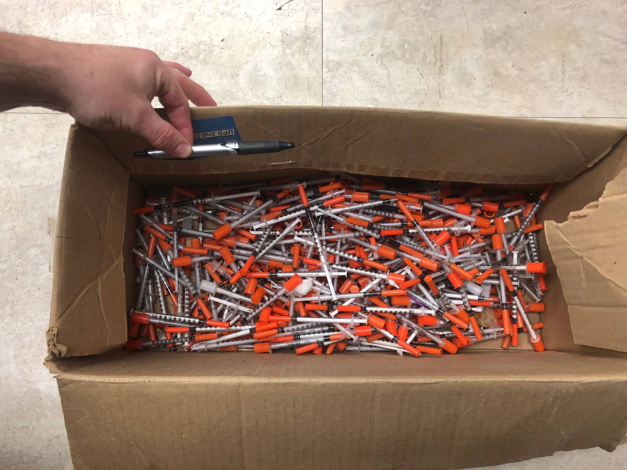 A citizen turned in this box of about 120 syringes, shown here Sept. 19, 2018, collected behind the Homer Marine Terminal on the Homer Spit on Sept. 11 in Homer, Alaska. (Photo provided/Homer Volunteer Fire Department)