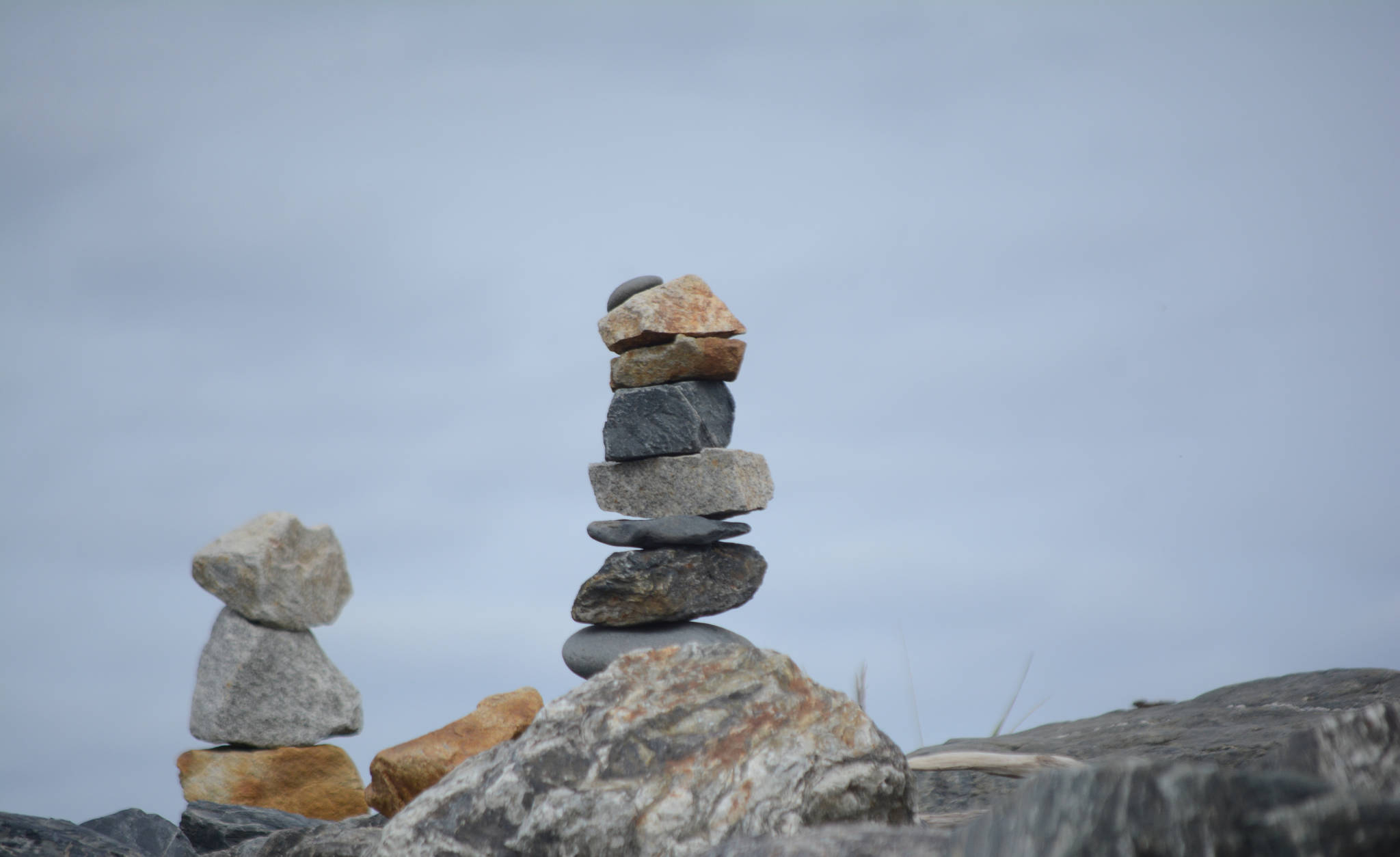 Two rock sculptures are part of dozens an artist made along the Homer Spit last week, as seen in this photo taken Friday, Sept. 21, 2018, in Homer, Alaska. (Photo by Michael Armstrong/Homer News)