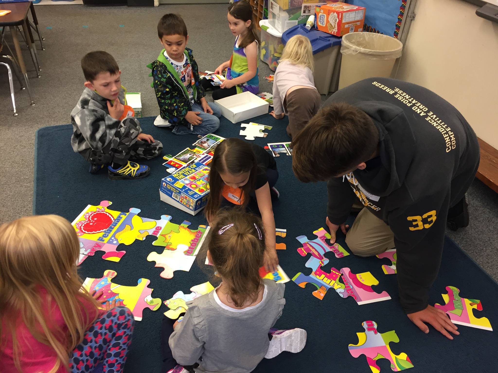 Homer High School senior Henry Russell works with Paul Banks Elementary School kindergarten students in Mrs. Wendy Todd’s classroom. (Photo by Wendy Todd)