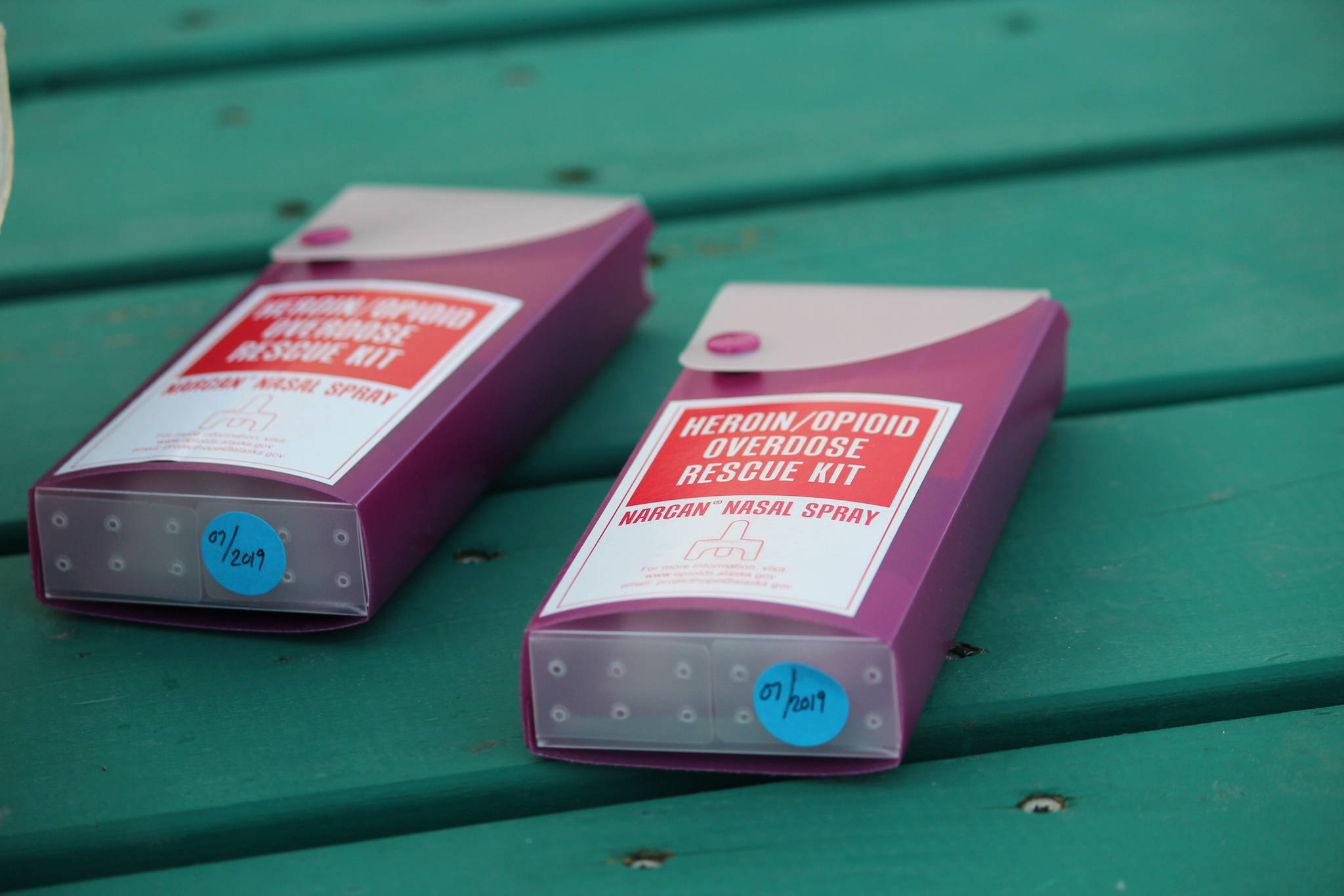 Two kits of the drug Naloxone, commonly called Narcan, rest on a picnic table before a Light the Night march Saturday, Sept. 29, 2018 at WKFL Park in Homer, Alaska. The kits are used to reverse the immediate effects of an overdose and can buy patients extra time to get to a hospital to be treated. (Photo by Megan Pacer/Homer News)