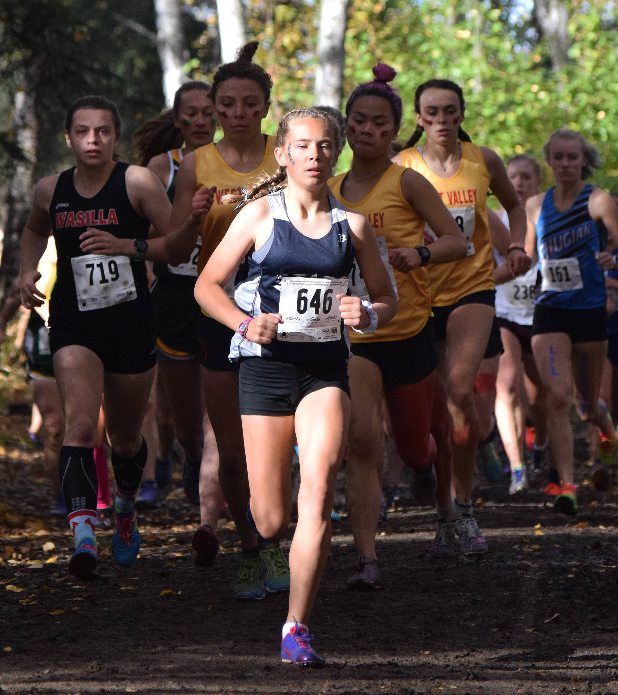 Soldotna freshman Jordan Strausbaugh (646) leads a pack of runners early in Saturday’s Division I girls race at the ASAA state cross-country running championships at the Bartlett Trails in Anchorage. (Photo by Joey Klecka/Peninsula Clarion)