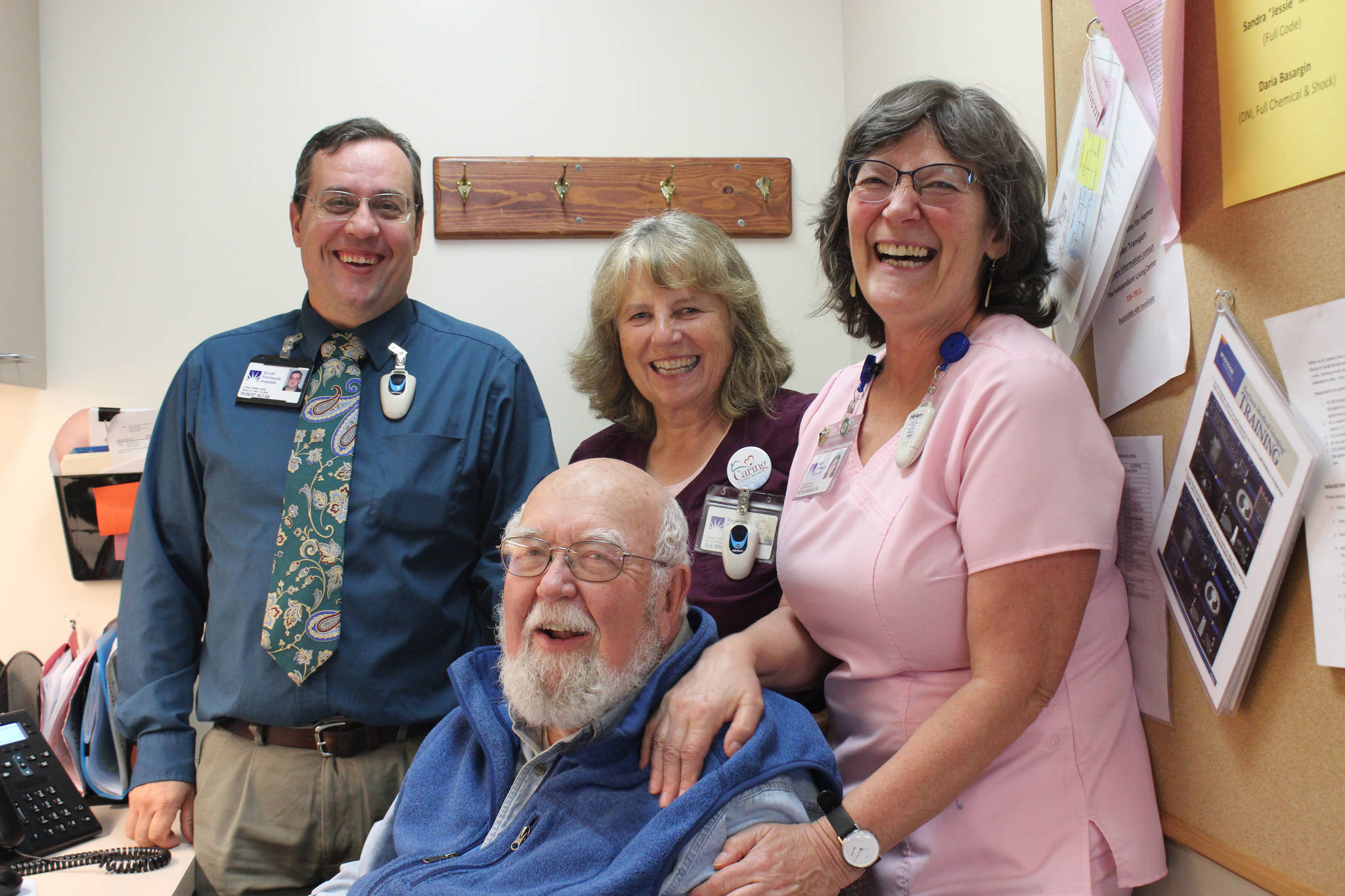 Dr. Paul Eneboe, front, with South Peninsula Hospital Long Term Care staff, from left to right, Robert Rutan, Sue Brooks and Ruth Lavrakas. (Photo by McKibben Jackinsky)